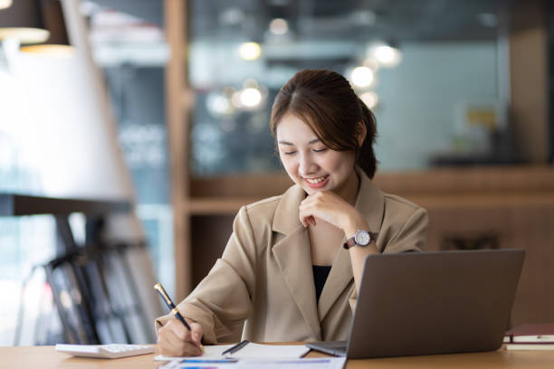 istock Young businesswoman working with laptop and documents on office desk. 1480992486