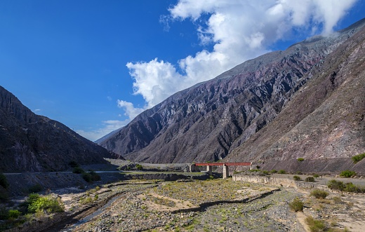 Salta, Argentina, November 9, 2019: View of a railway bridge in the valley along the dry river Río Rosario in Argentinian Andes.