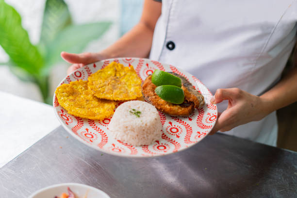Food plate served with fish, rice and patacon