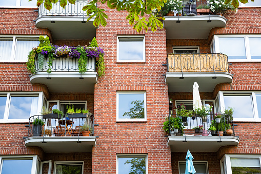 Beautiful building with many flowers on balconies in Hamburg, Germany.