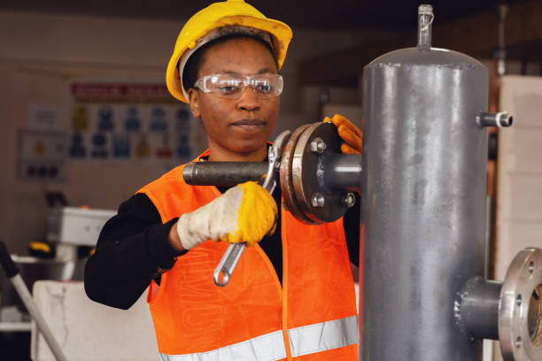 istock Young  Woman Learning industrial pipe assembly 1480996575