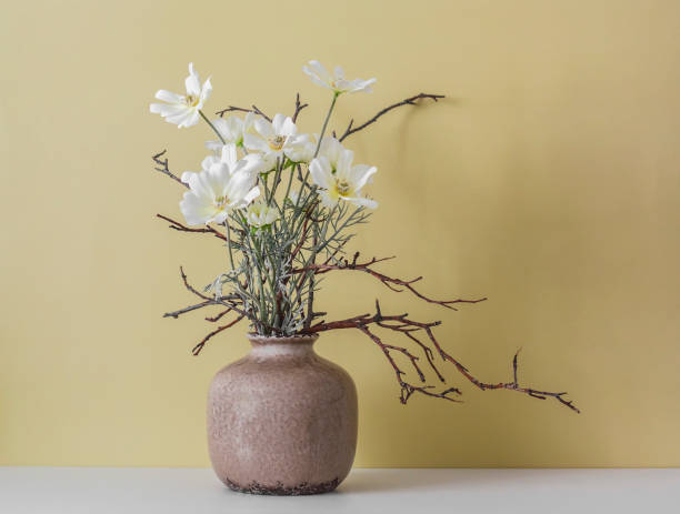 istock Flower arrangement in a ceramic vase on a yellow background. Copy space 1480997494