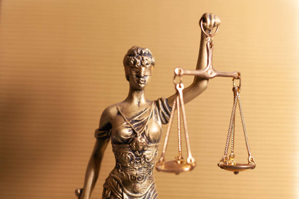 istock lady justice on golden background 1480997754