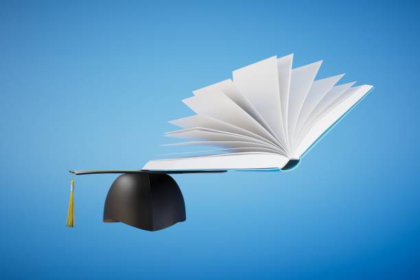 istock obtaining higher education. the master's hat next to the open book on a blue background. 3D render 1481002209