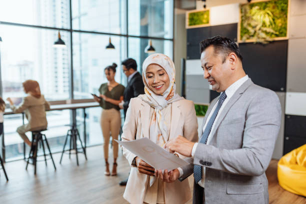 istock Diverse Asian business people in modern office, working together and sharing information 1481004613
