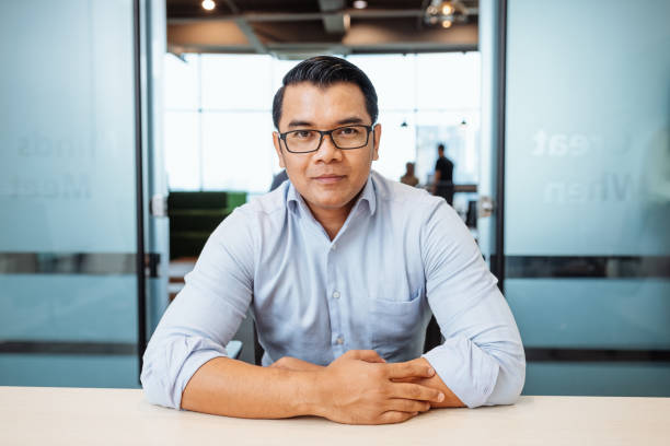 istock Handsome Asian businessman in office, looking at camera 1481005460