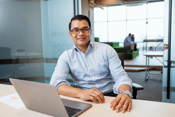 istock Handsome Asian businessman in office, looking at camera 1481005462