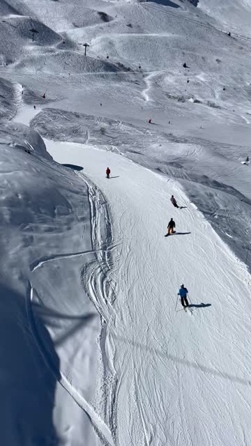Skiers on the slopes of French alps by winter