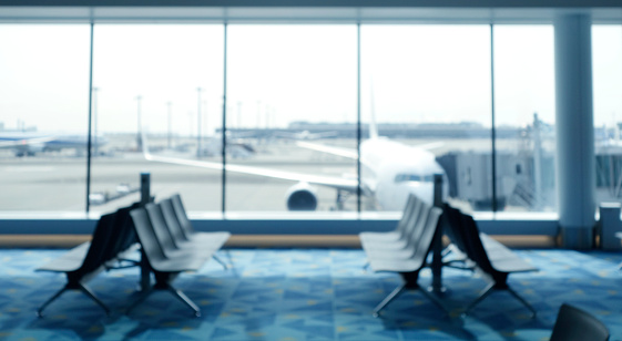 BLURRED OFFICE BACKGROUND, MODERN BUSINESS HALL WITH LIGHT REFLECTONS ON THE FLOOR,abstract blur in airport for background.