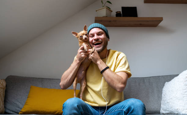 istock Cheerful pet owner and his little dog. 1481011079