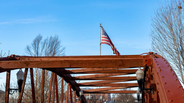 Red painted bridge and blue sky with American Flag