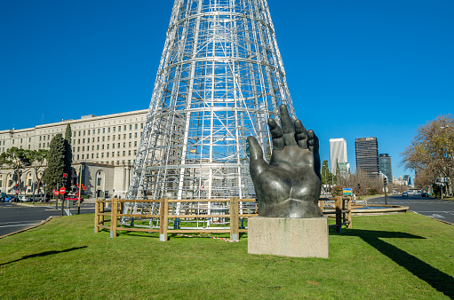 Madrid, Spain - January 12, 2022: The Hand, a bronze sculpture by the Colombian sculptor Fernando Botero, bought by Telefonica in 1994. In April 1995 Telefonica loaned the sculpture to the city of Madrid, Spain and it was installed on Paseo de la Castellana