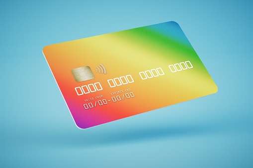 colorful plastic credit card on a blue background. 3D render.