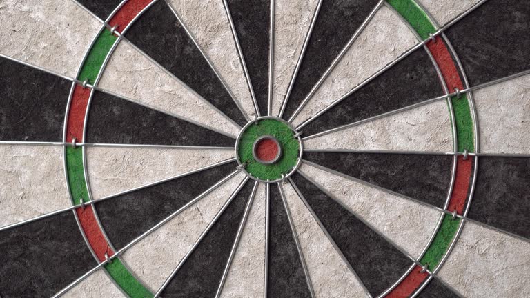 The dartboard slowly rotates. Close up.