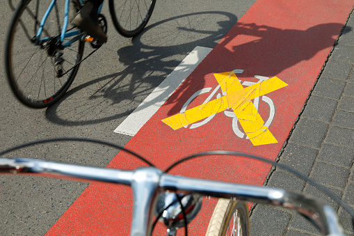 Strikethrough bicycle symbol on a bicycle lane along a road in Cologne