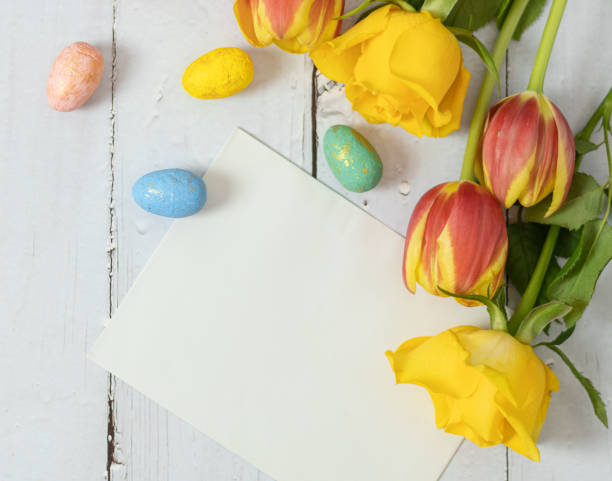 istock Flowers, Easter eggs and bunnies on a white wooden table. 1481017081