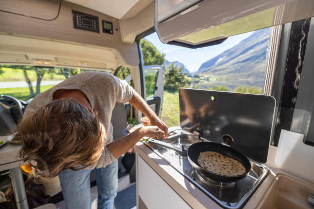 istock Man cooking in a van, lake view 1481017676