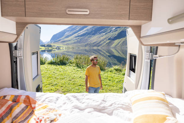 istock Man contemplates nature, POV from the back of a van 1481017921