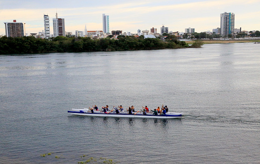 juazeiro, bahia, brazil - april 4, 2023: People paddling a hawaiian canoe in the waters of the Sao Francisco river in the city of Juazeiro, in the north of Bahia.