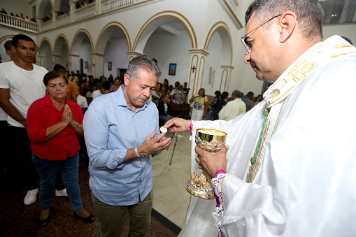 serrinha, bahia, brazil - april 6, 2023: distribution and consecrated ostia during a mass in the city of Serinha.