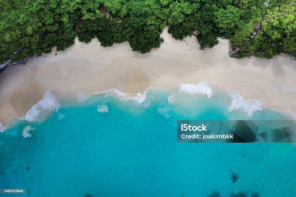 Idyllic white sand beach in Bali Indonesia Abstract view of an idyllic white sand beach in Indonesia. Wave Pattern Stock Photo