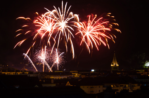 Bright fireworks light up the night sky for Bastille day, a major holiday in Annecy, France
