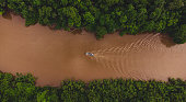 Pantanal by Drone, the biggest savanna in the world - Big river -   Mato grosso do sul, boat in the river and big mountains .