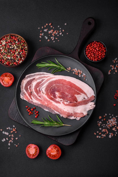 istock Fresh raw bacon sliced with spices and herbs 1481025548