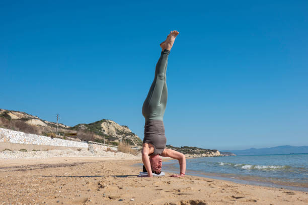 istock Woman practising yoga on the beach 1481027803