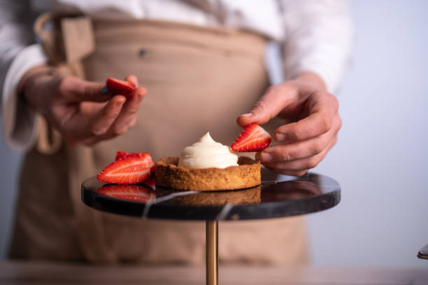 istock Female chef making a cake with strawberries 1481028903