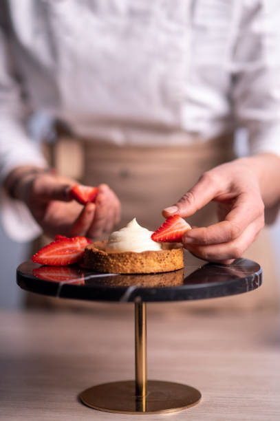 istock Female chef making a cake with strawberries 1481028907