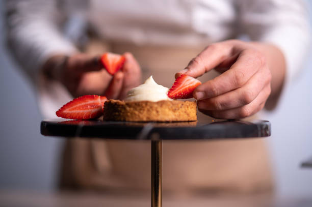 istock Female chef making a cake with strawberries 1481028911