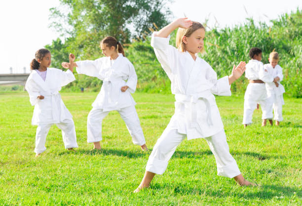 istock Little girl make karate exercises in park 1481030639