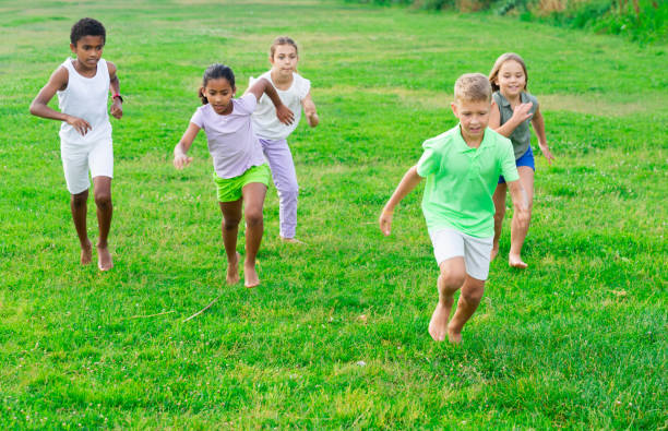 istock Children running on green grass 1481030651