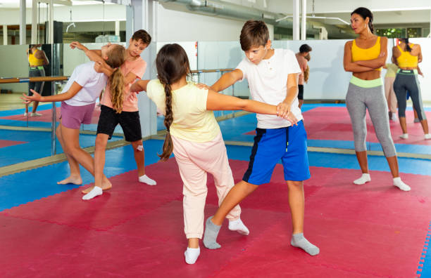istock Kids in pair exercising self-defense movements 1481030784