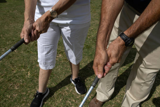 istock Golf instructor teaching how to a female apprentice to adjust her grip 1481030871