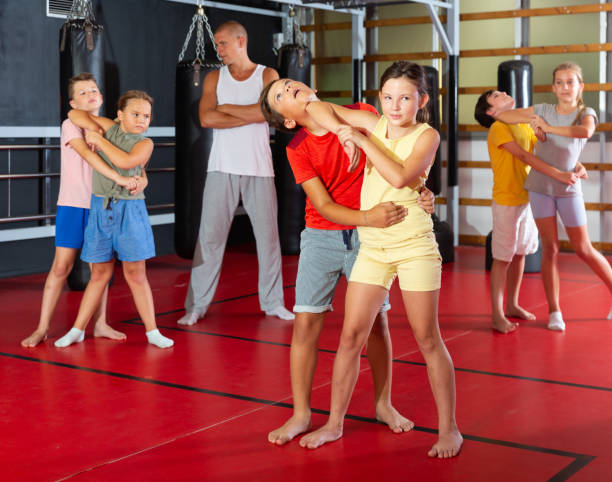 istock Kids in pair exercising self-defense movements 1481031524