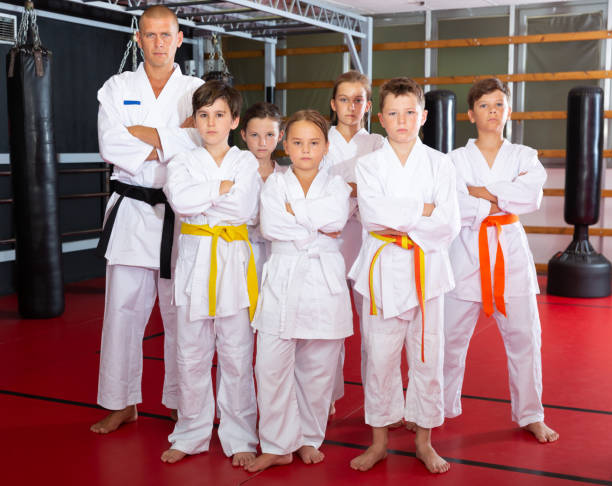 istock Children with their male instructor posing in karate class 1481031533