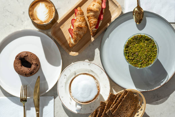 Table with various cookies, tarts, cakes, coffees and sandwiches Marble table with various cookies, tarts, cakes, coffees and sandwiches. carrot cake day stock pictures, royalty-free photos & images