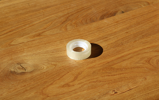 Small roll of sticky table on wooden table