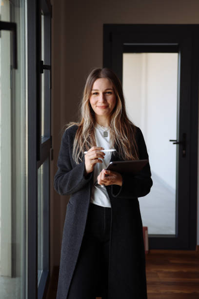 istock Female architect standing using a tablet in a house being renovated 1481040947