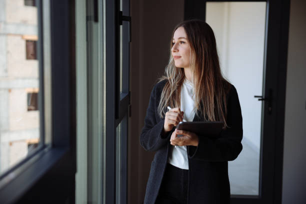 istock Female architect standing using a tablet in a house being renovated 1481041070