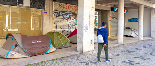 camping tents under the arches of residential and service buildings in a commercial area on Avenida Almirante Reis in Lisbon to accommodate homeless people from Asian countries such as Nepal and India