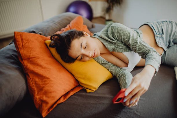 istock Young pregnant woman lying in her bed while using a smartphone 1481053535