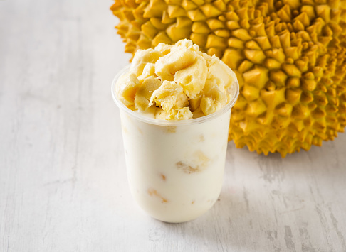 Fresh Durian Smoothie served in disposable glass isolated on background top view taiwan food