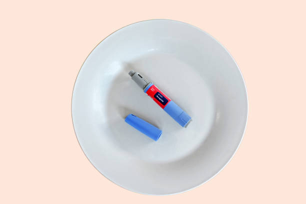 Semaglutide pen Semaglutide injecting pen with lid on a white plate wegovy stock pictures, royalty-free photos & images