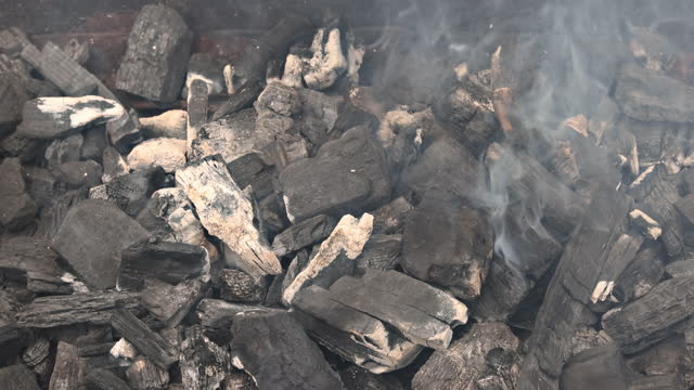 It is important to prepare the coals so be used for grilling meat over smoke and flames