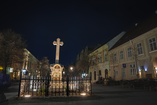 Picture of the main square of Zemun, Veliki Trg, with its typical hungarian architecture buildings and a catholic calvary at night. Zemun is a suburb of Belgrade, Serbia, famous for its specific architecture due to the Austrian period