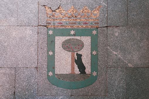 Colorful El Oso y el Madroño crest on the sidewalk of Madrid Spain