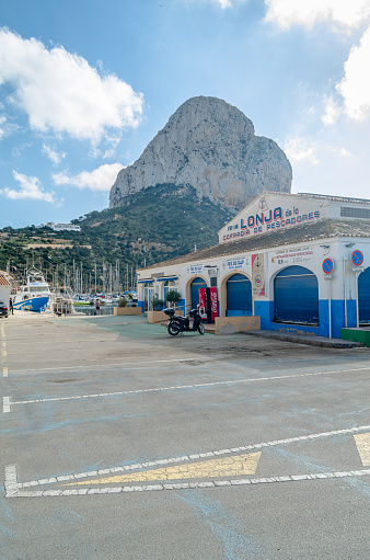 Calpe, Spain - January 26, 2022: View of the fishing port of Calpe, with the Peñon de Ifach in the background, Alicante province, Valencian Community, Spain